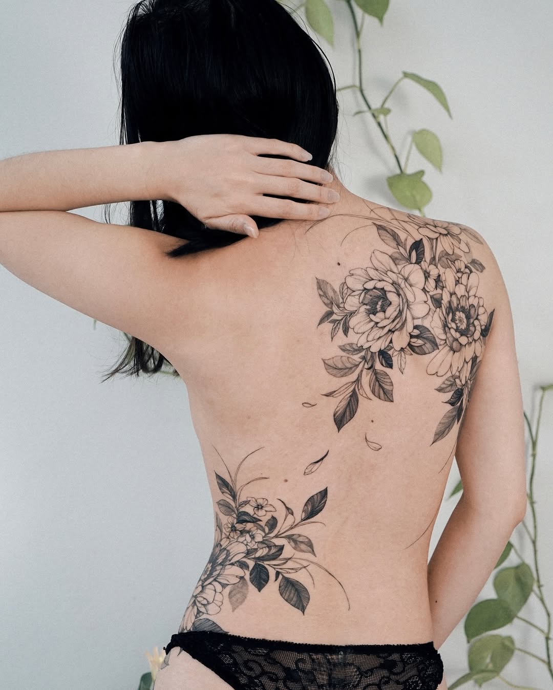 Elegant floral back tattoo design for women