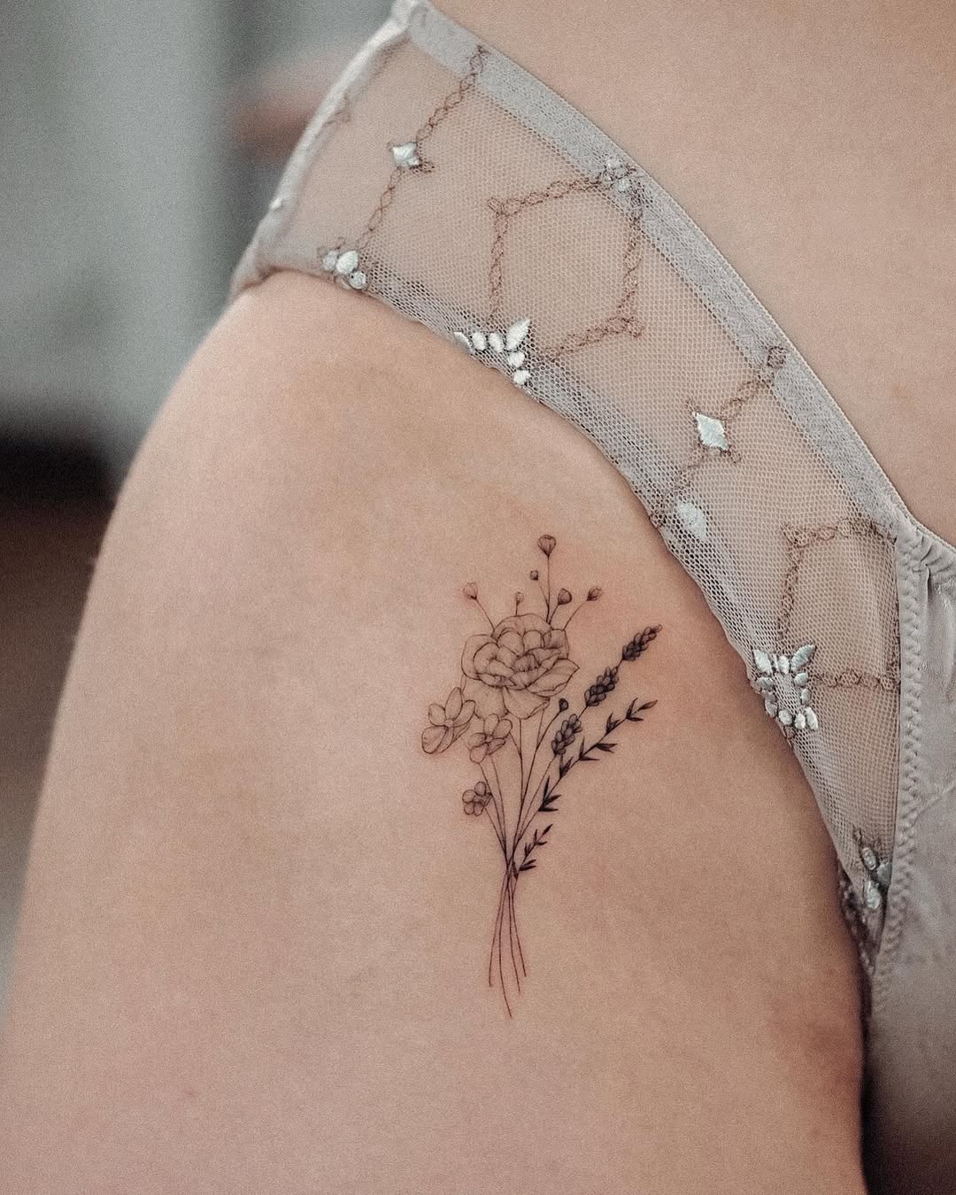 Elegant floral tattoo on the hip area