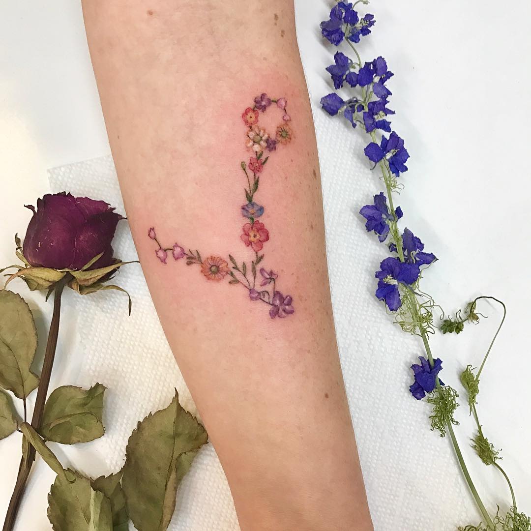 Delicate floral Pisces symbol tattoo inspiration