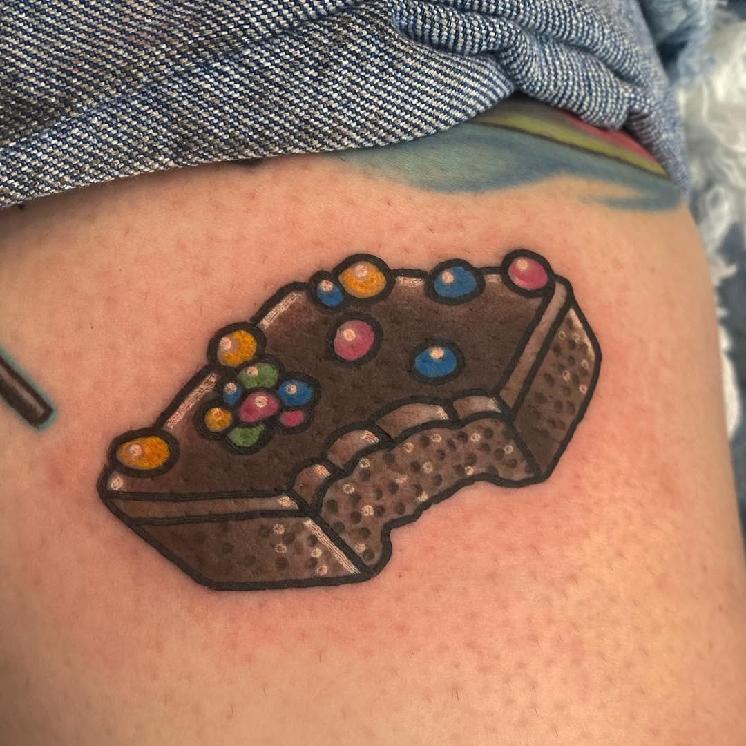 Whimsical pastry tattoo with colorful toppings