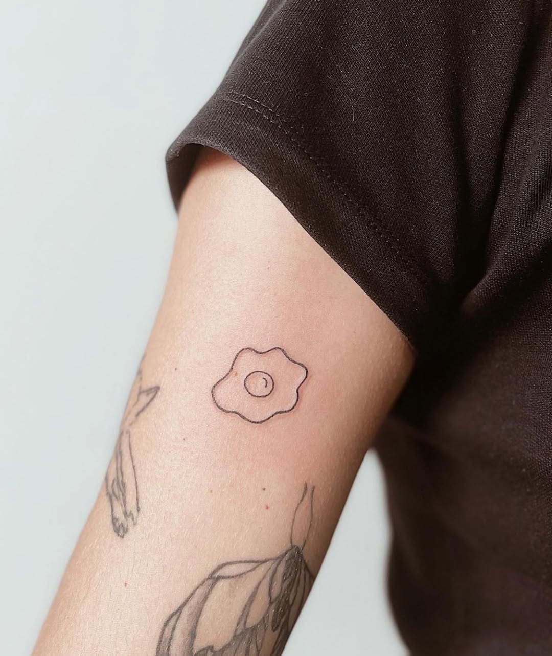 Minimalist fried egg tattoo design inspiration