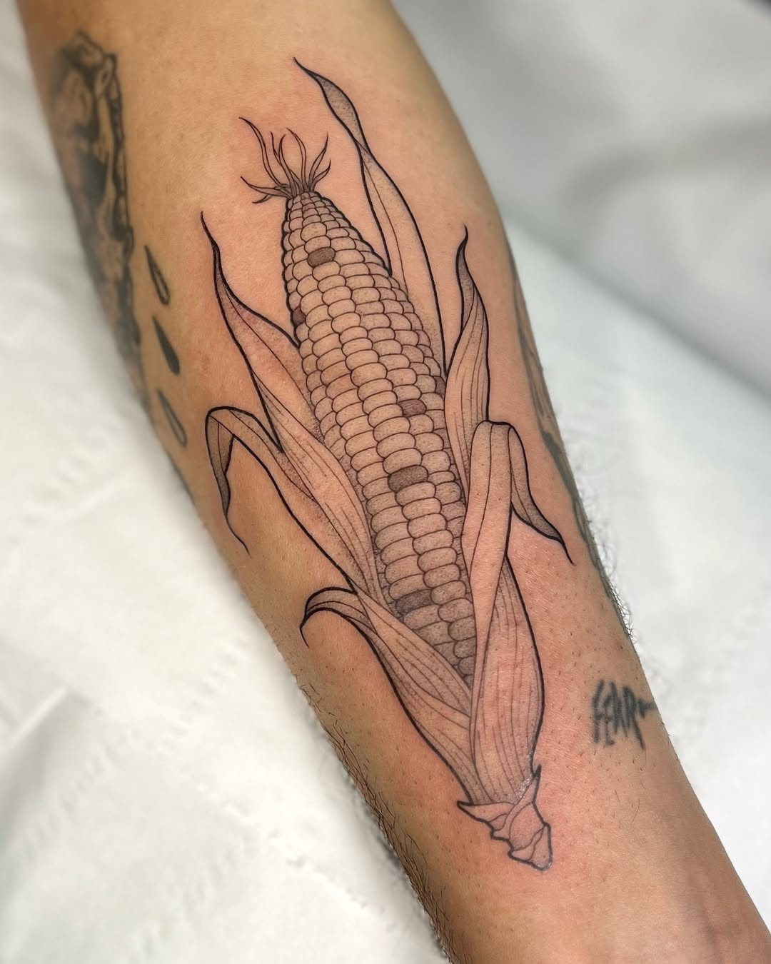 Elegant corn tattoo with intricate detailing