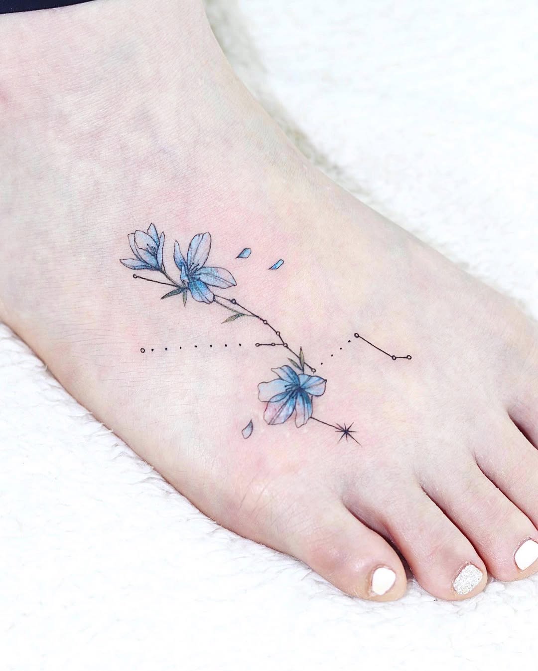 Delicate floral tattoo with constellation detail