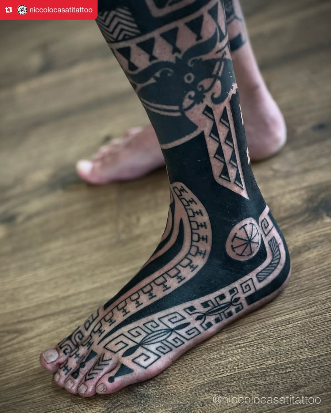 Stunning black and white tribal foot tattoo