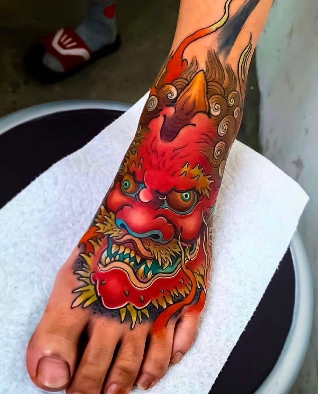 Bold dragon tattoo igniting foot artistry