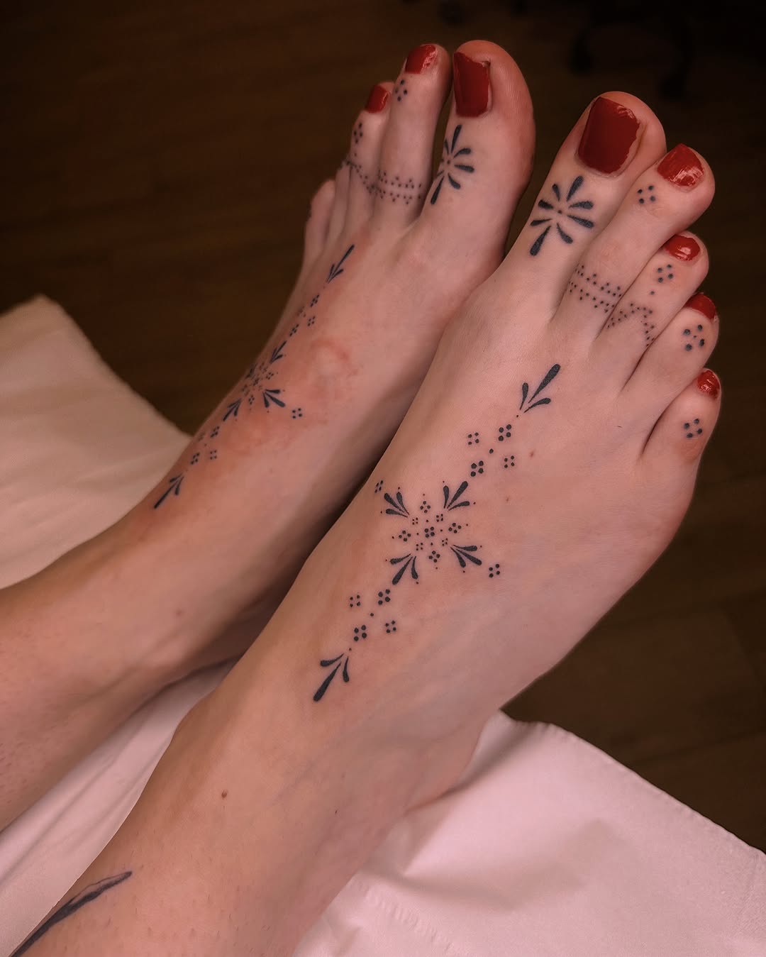 Delicate floral foot tattoo design inspiration