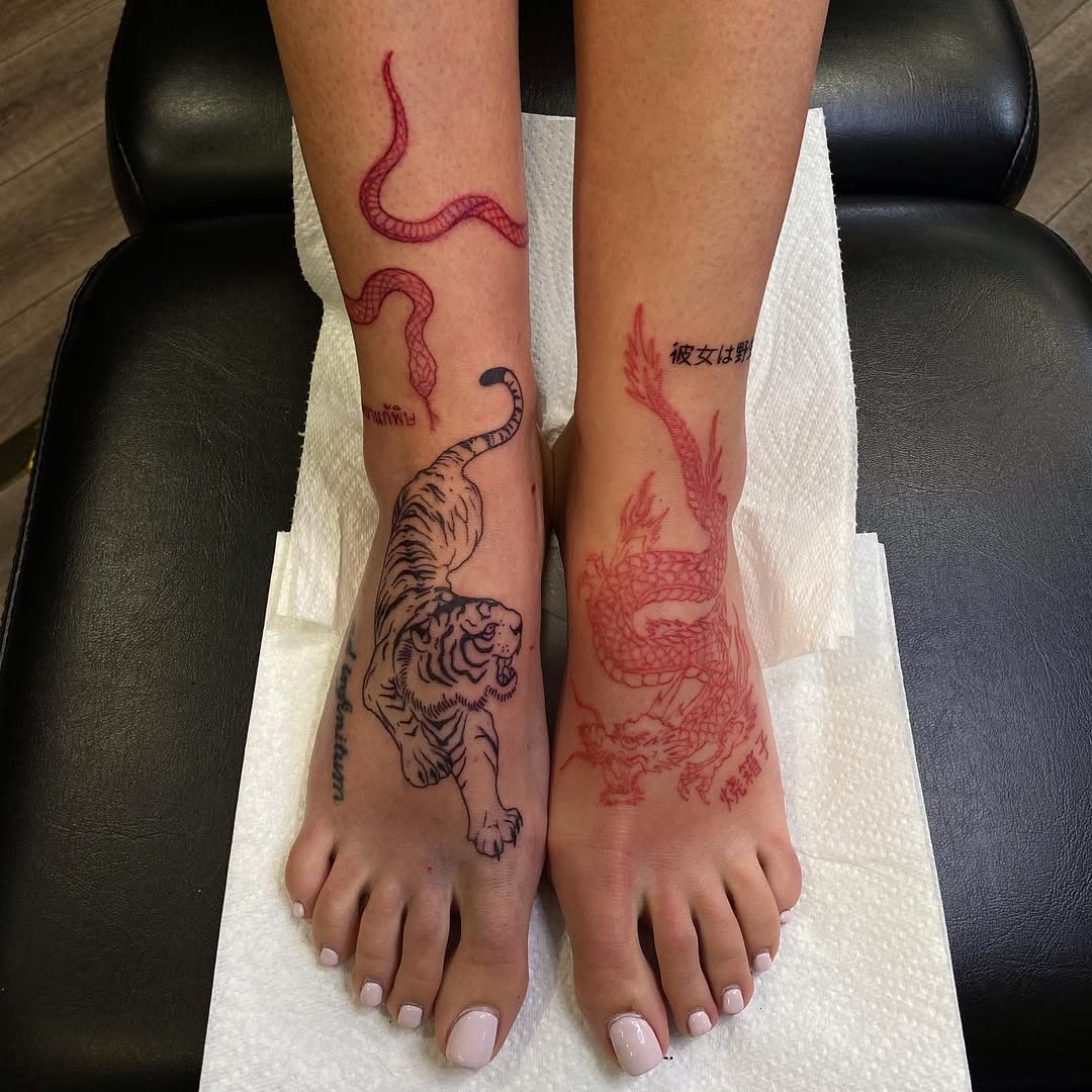 Bold foot tattoos featuring fierce animals