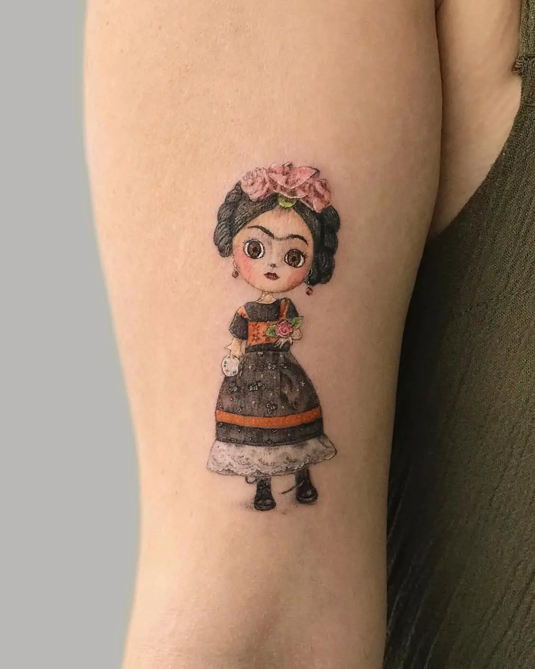 Whimsical Frida Kahlo Tattoo with Floral Accents
