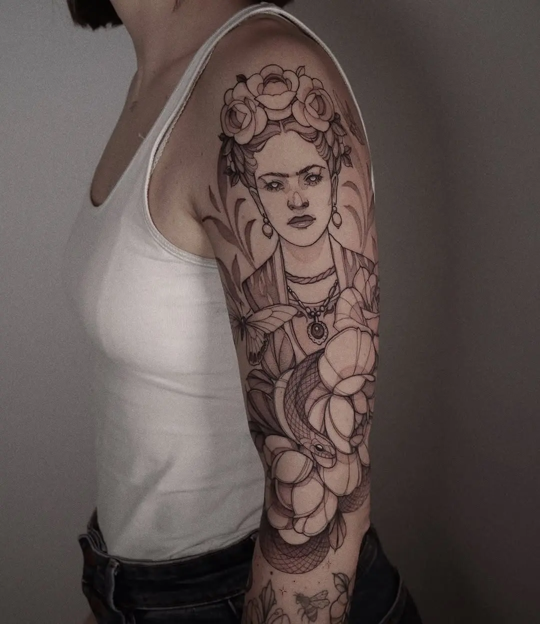 Intricate Frida Kahlo tattoo featuring florals