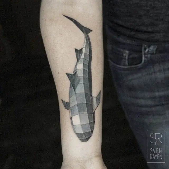 Stylish geometric shark tattoo on forearm