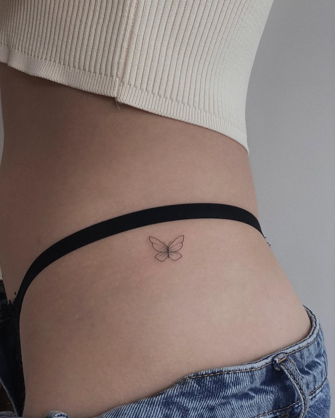 Minimalist Butterfly Tattoo on the Hip