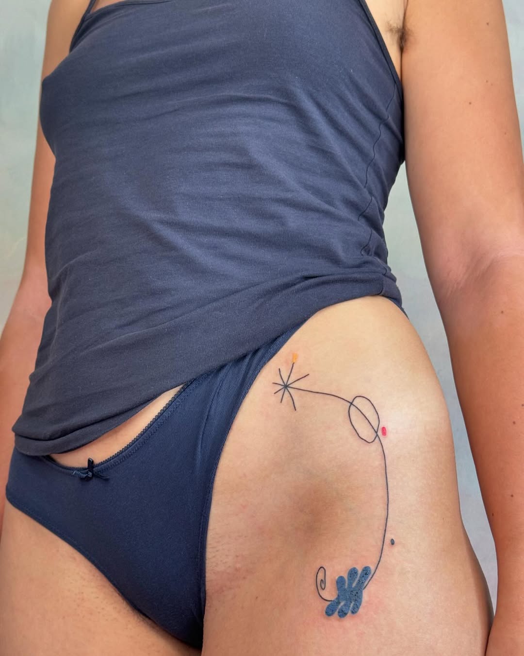 Stylish Hip Tattoo with Whimsical Elements