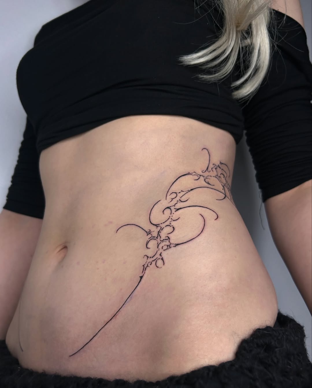 Elegant hip tattoo with intricate linework