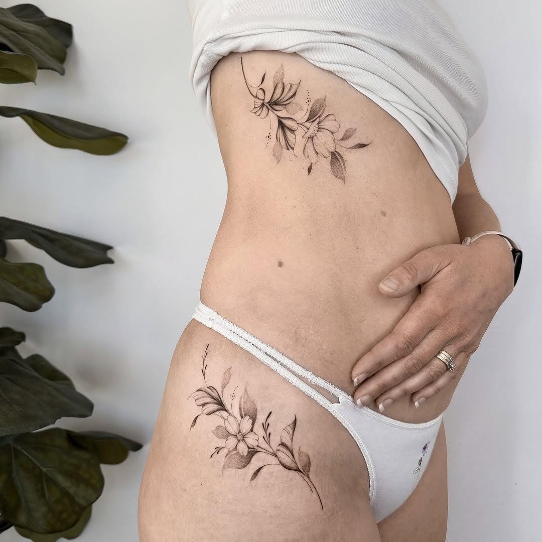 Elegant floral hip tattoo design with delicate details