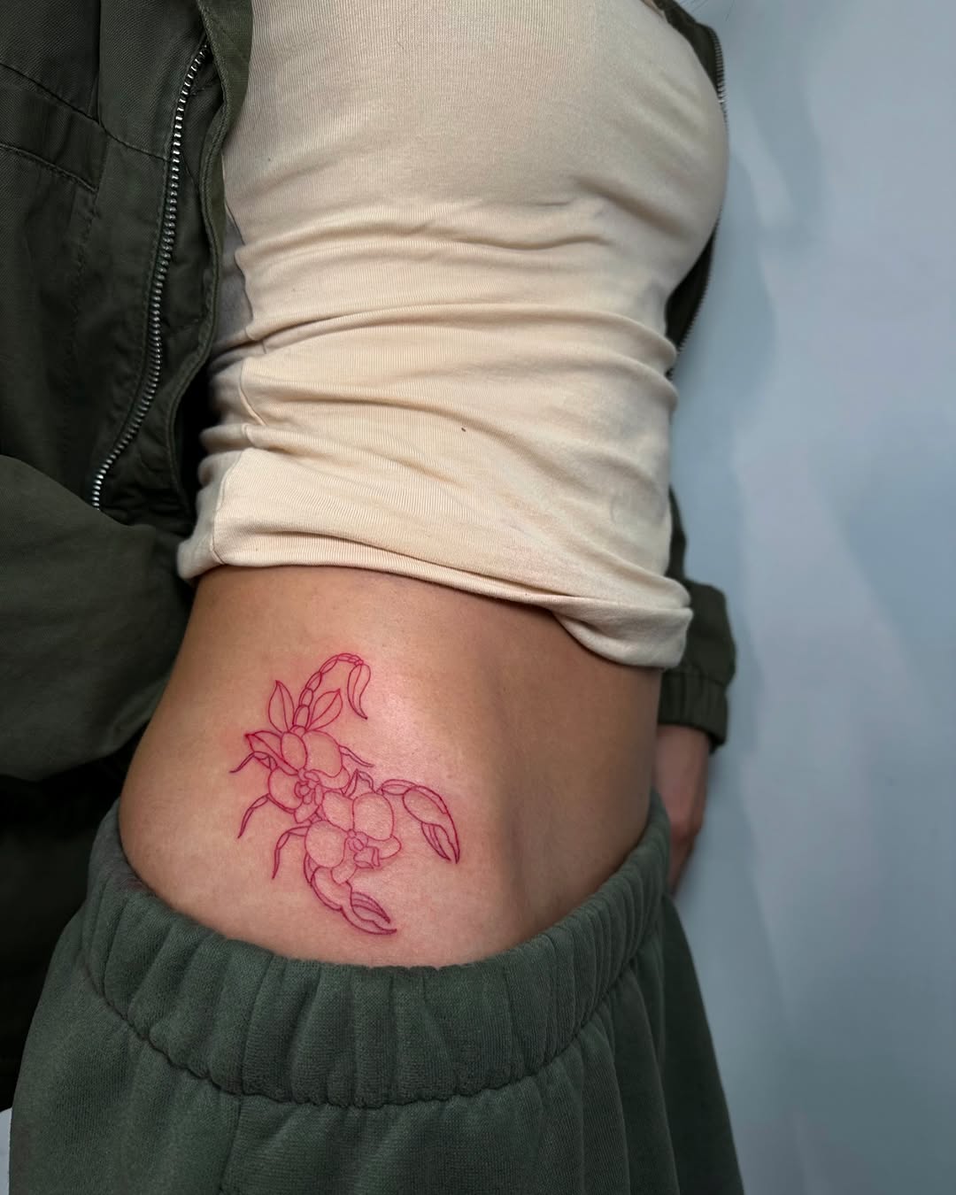 Eye-catching floral scorpion hip tattoo