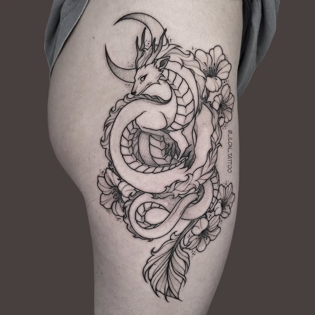 Elegant hip tattoo featuring dragon and flowers