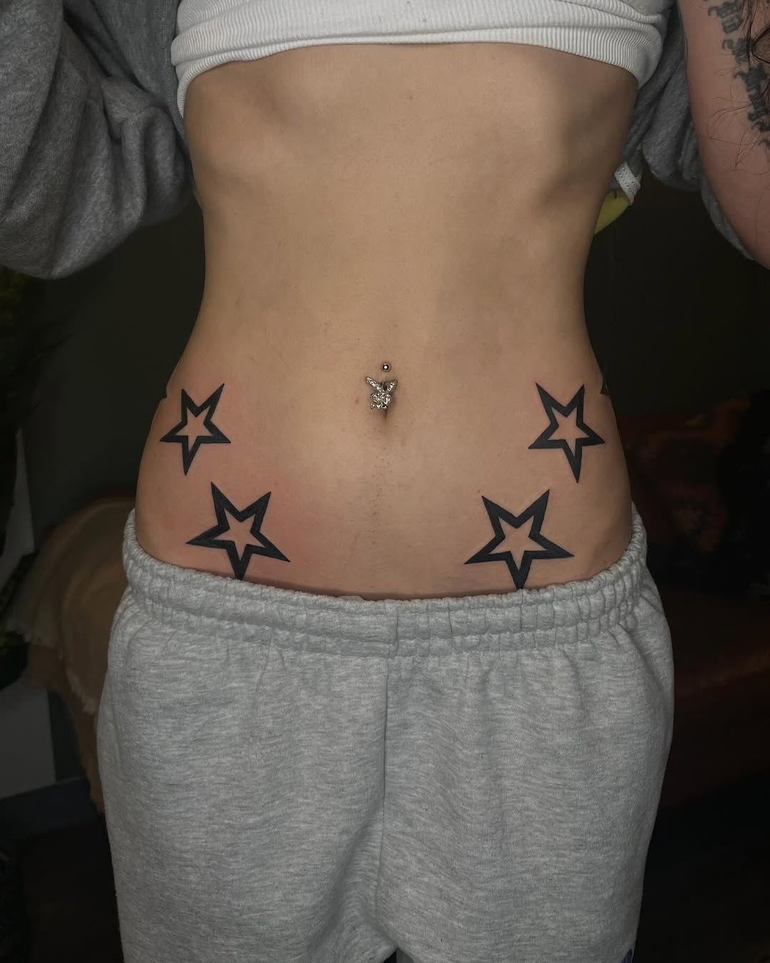 Chic star tattoos adorning the hip area