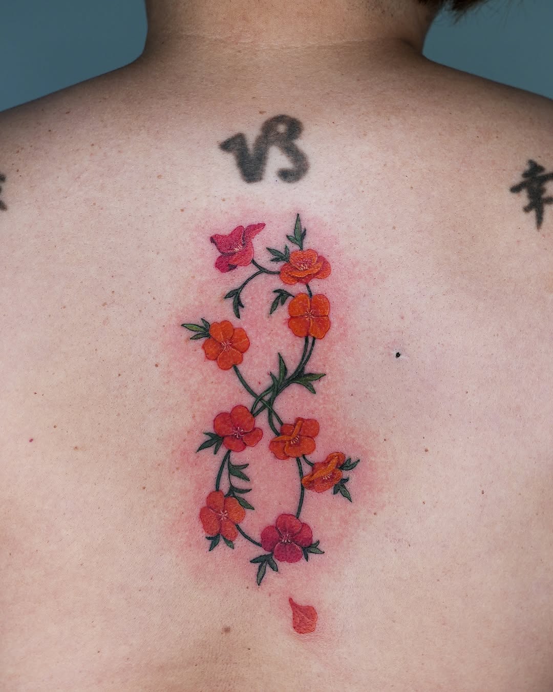 Delicate infinity floral tattoo on the back
