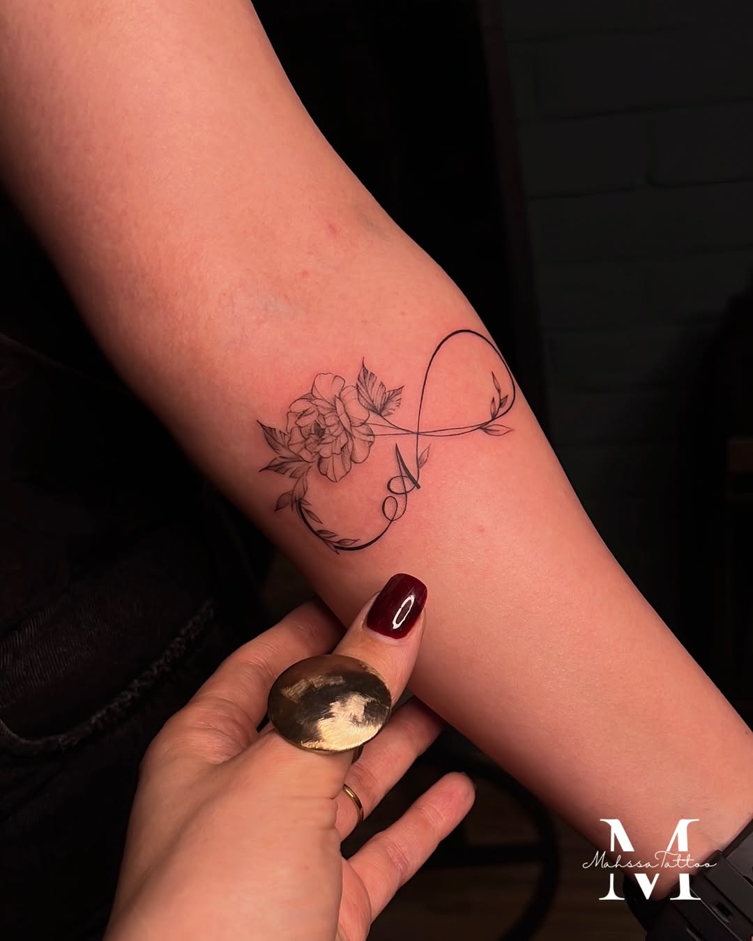 Elegant infinity tattoo with floral details