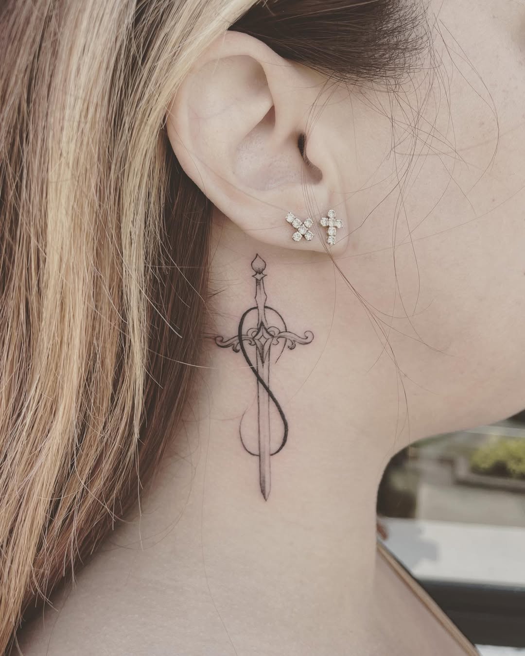 Elegant infinity sword tattoo on the neck
