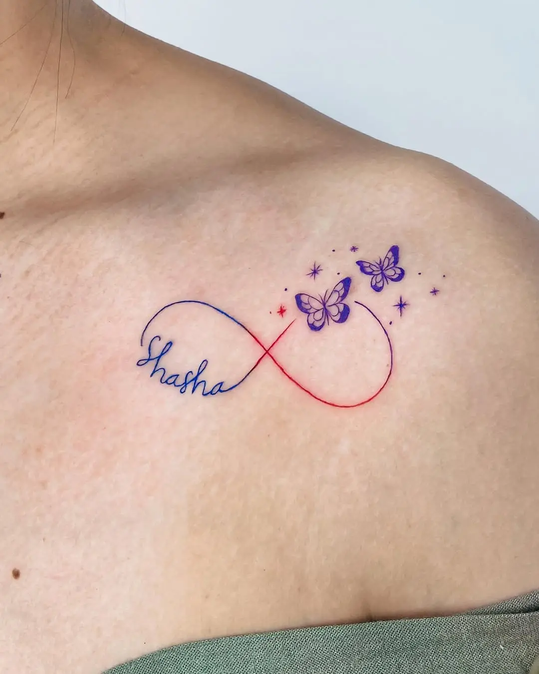 Unique infinity tattoo featuring delicate butterflies