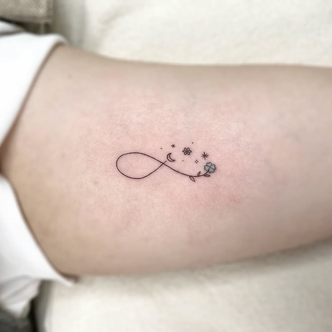 Minimalist infinity tattoo with floral elements