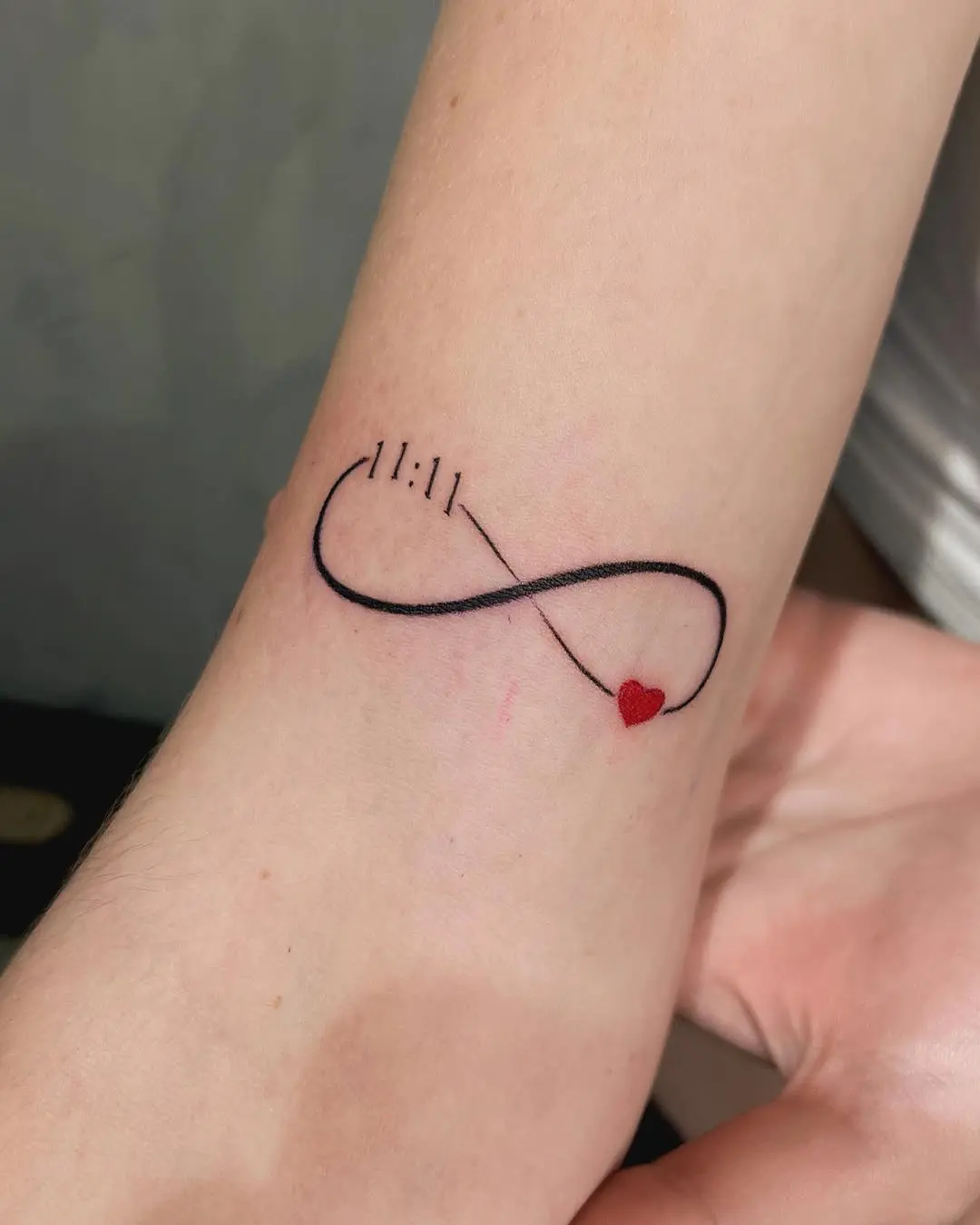Elegant infinity tattoo with meaningful symbols