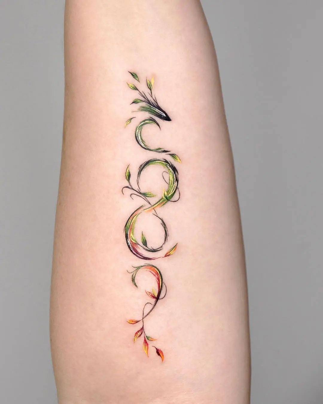 Elegant infinity tattoo with vibrant floral elements