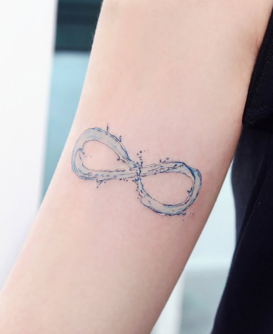 Water-Inspired Infinity Tattoo on Arm