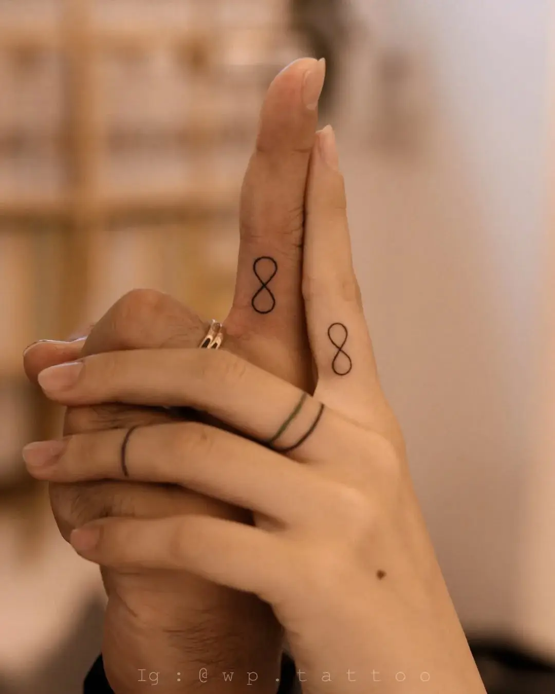 Stylish infinity tattoos on fingers