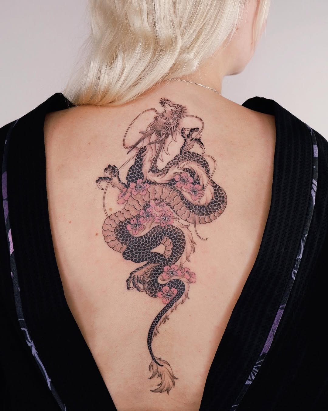 Elegant dragon and floral back tattoo design