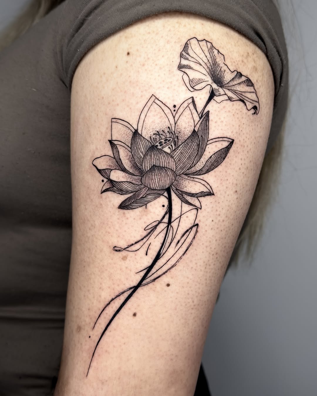 Elegant lotus tattoo with delicate floral details