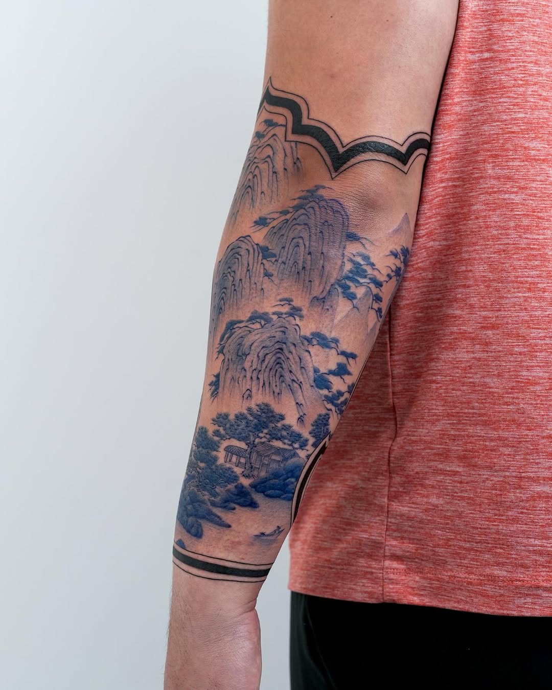 Stunning blue landscape tattoo on the arm