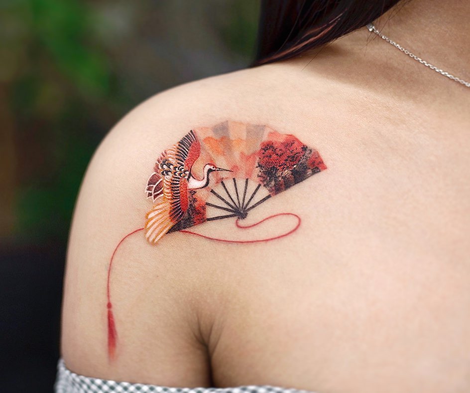 Elegant crane tattoo with vibrant fan design