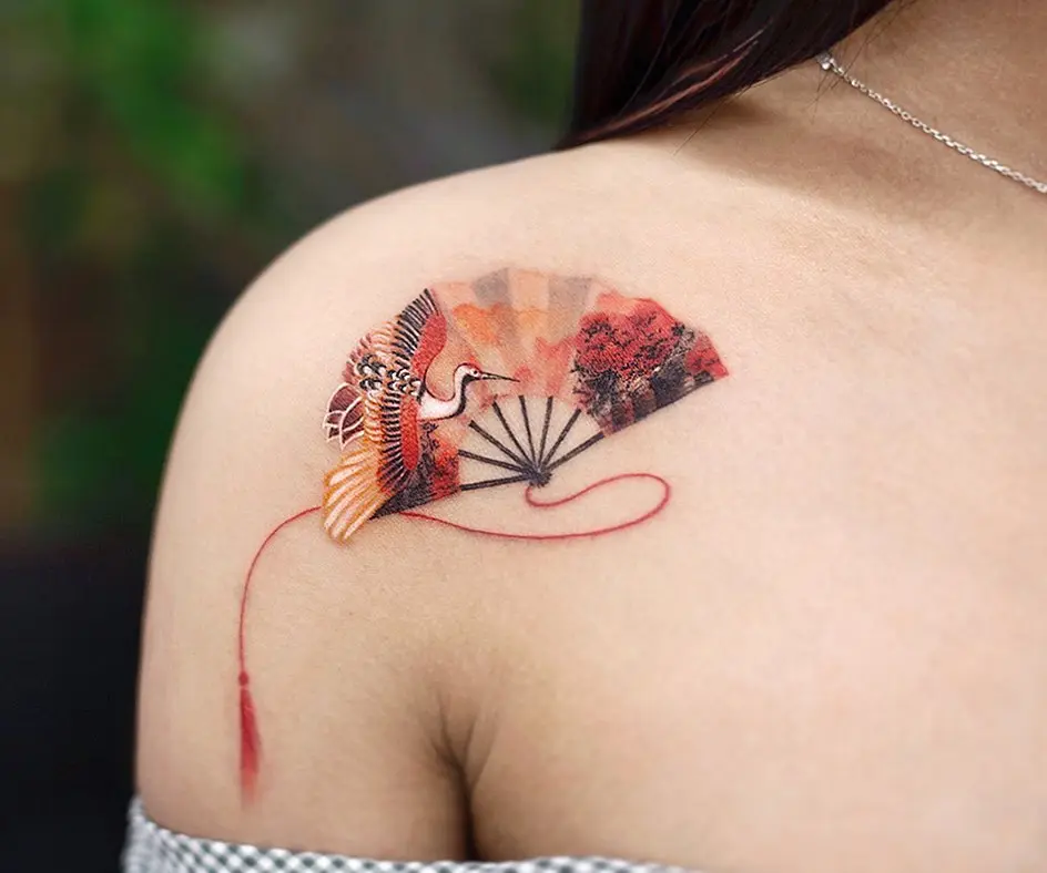 Elegant crane tattoo with vibrant fan design