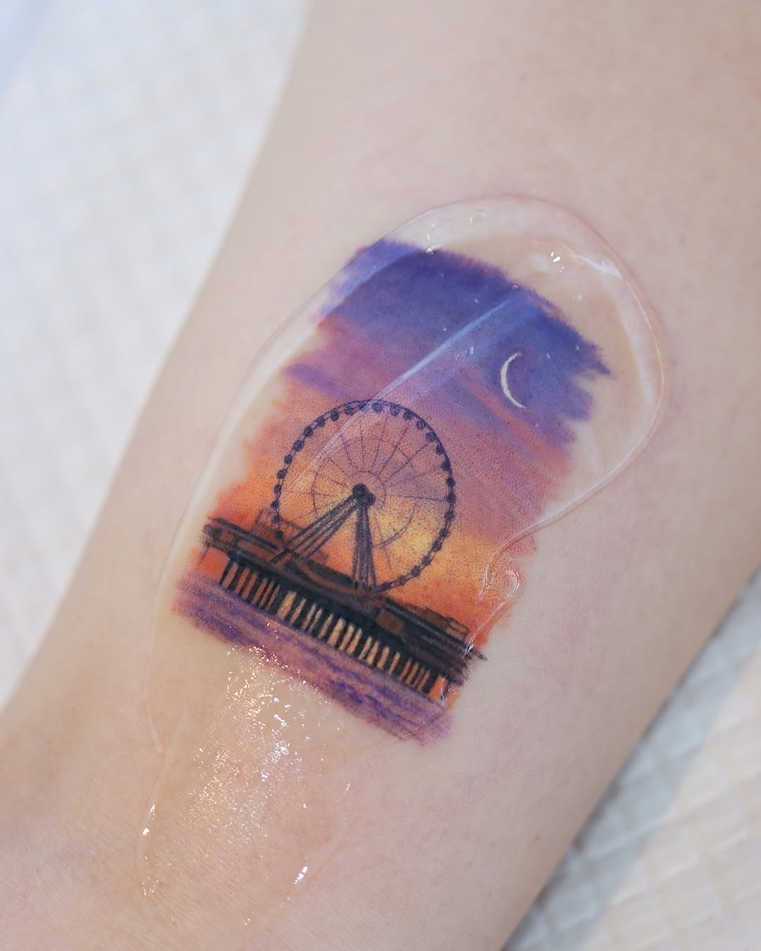 Serene Ferris wheel tattoo at sunset