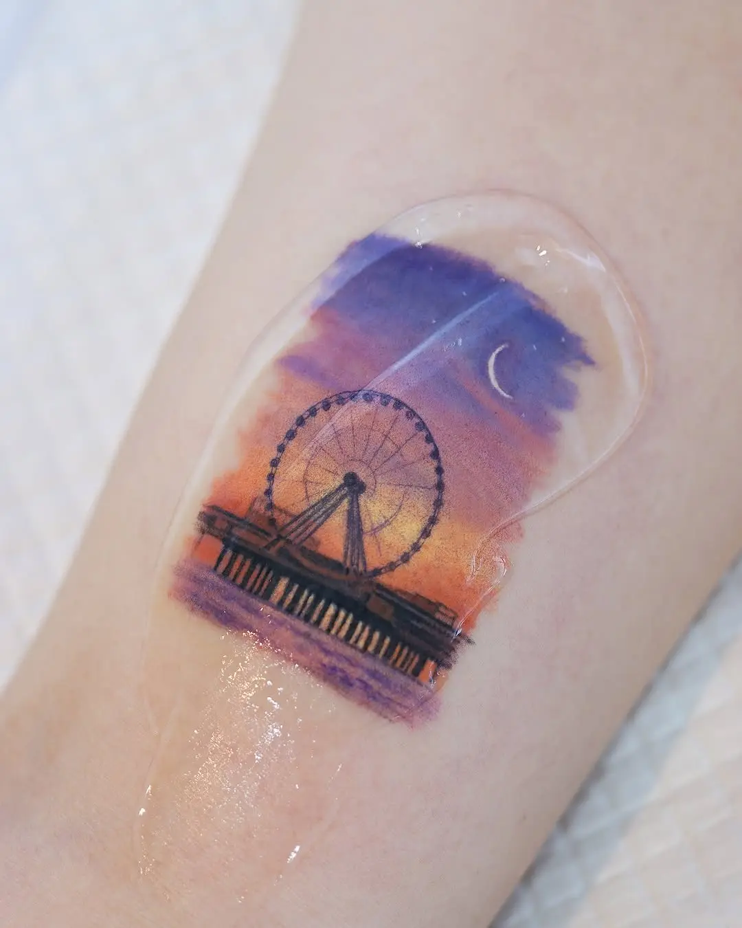Serene Ferris wheel tattoo at sunset