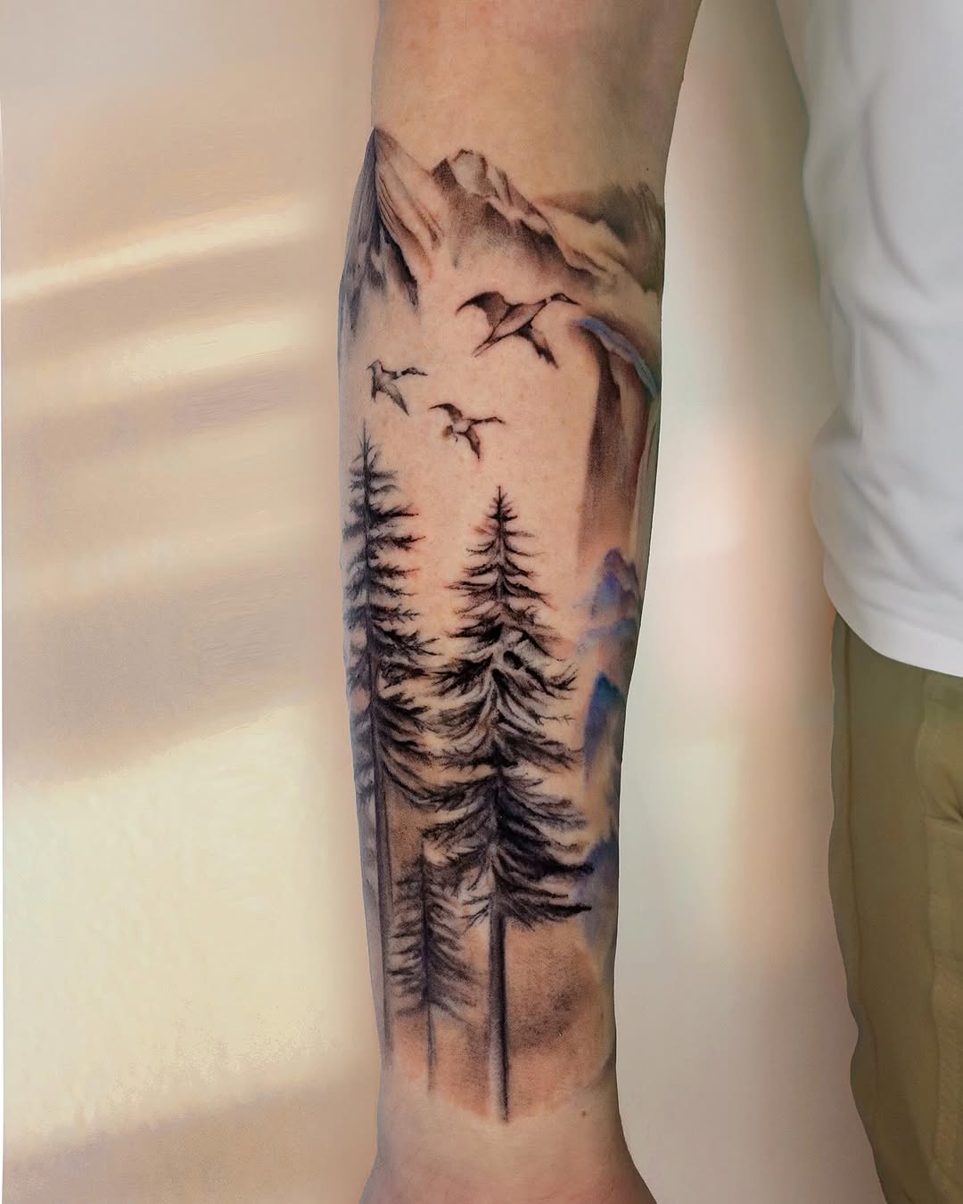 Majestic mountain and forest landscape tattoo