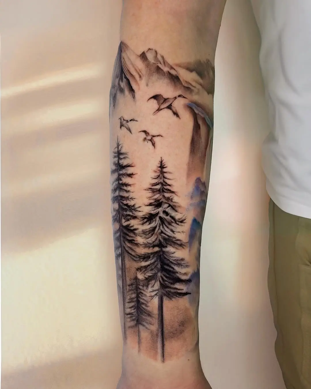 Majestic mountain and forest landscape tattoo