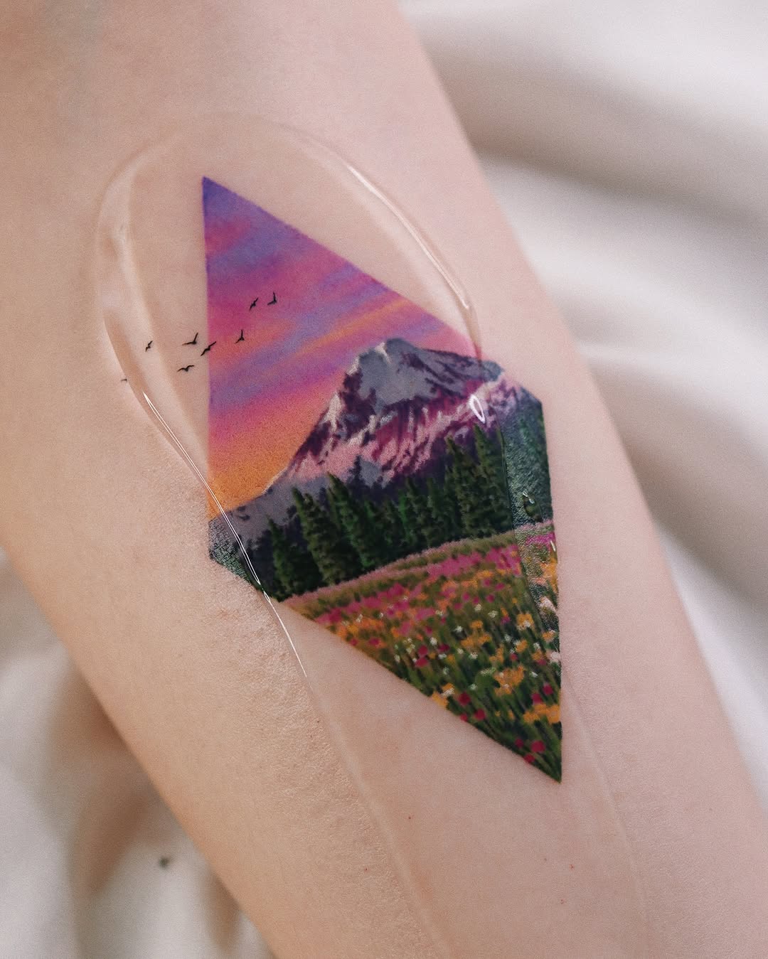 Stunning geometric landscape tattoo with vibrant colors