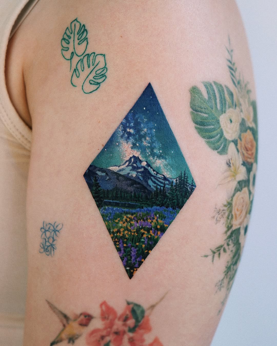 Vivid Landscape Tattoo with Night Sky and Flowers