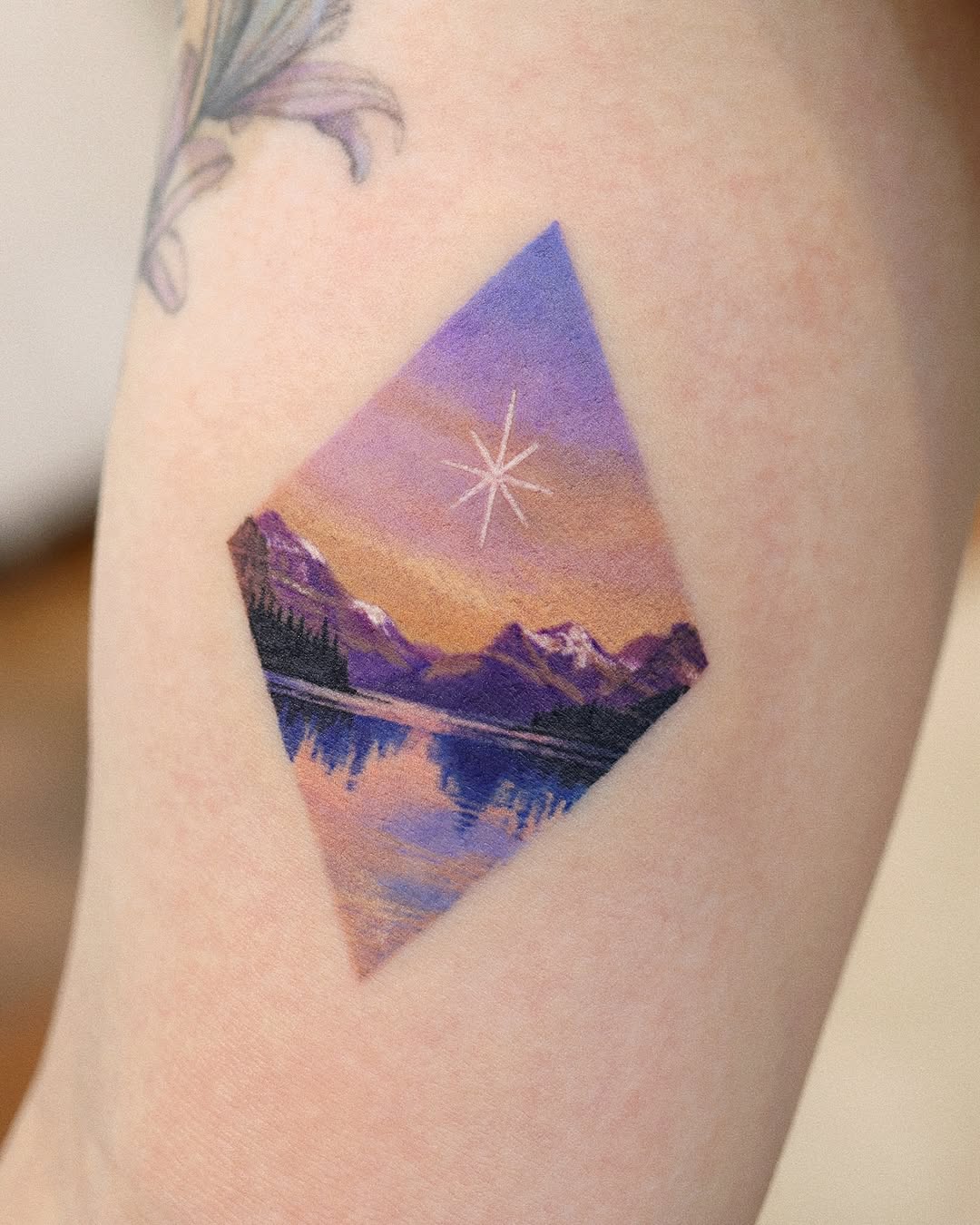 Stunning mountain landscape tattoo with star detail