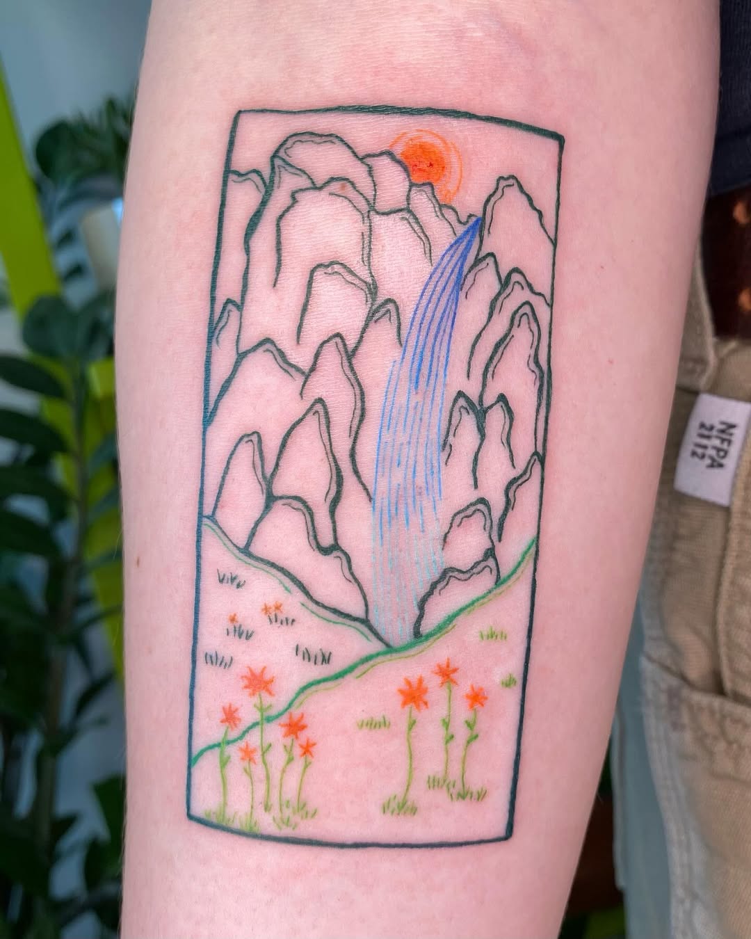 Nature-inspired mountain and waterfall tattoo design