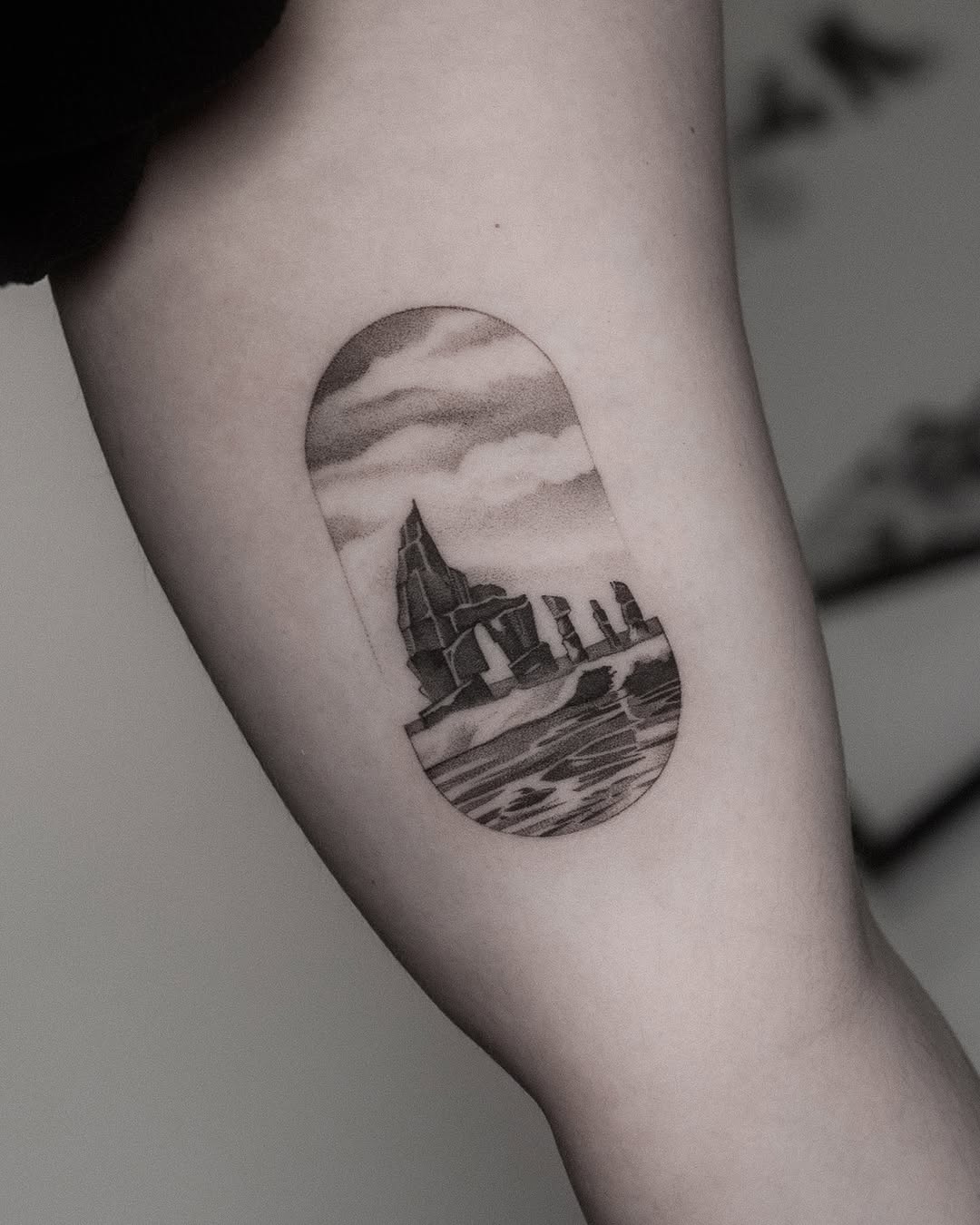 Unique landscape tattoo with rocks and water