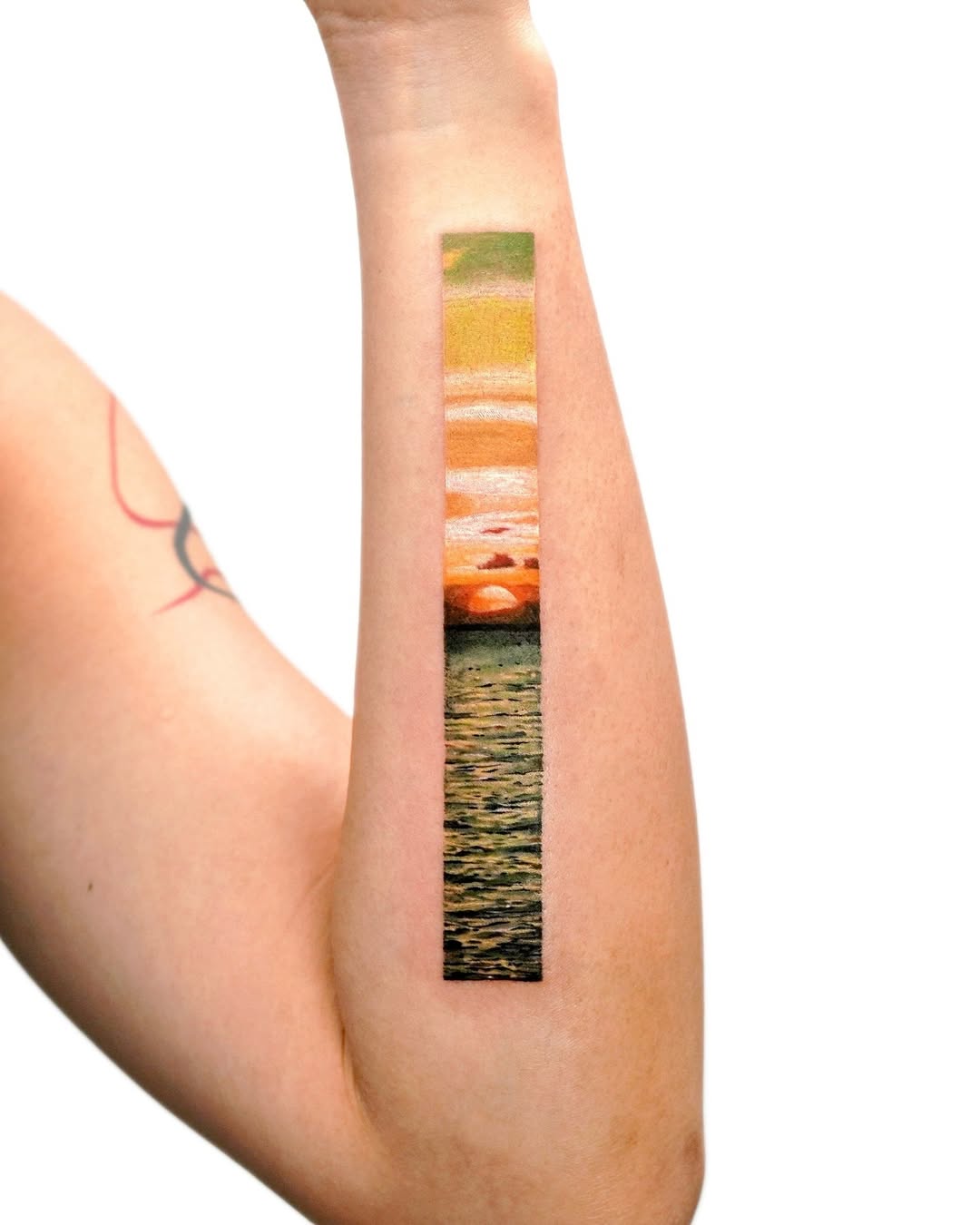 Stunning sunset landscape tattoo on forearm