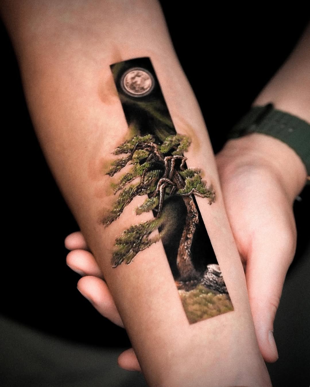 Stunning landscape tattoo of a tree and moon