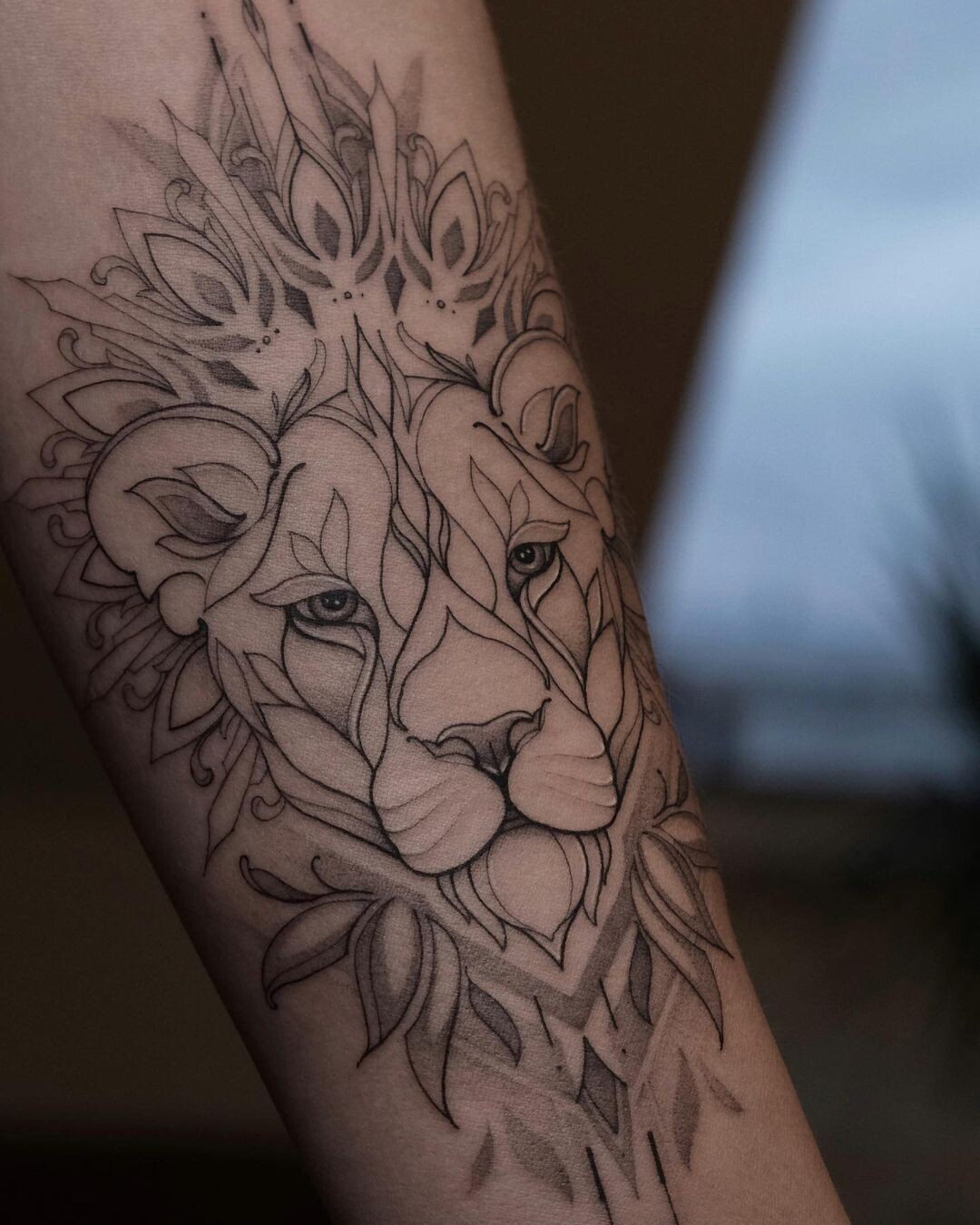 Intricate lion design with floral elements