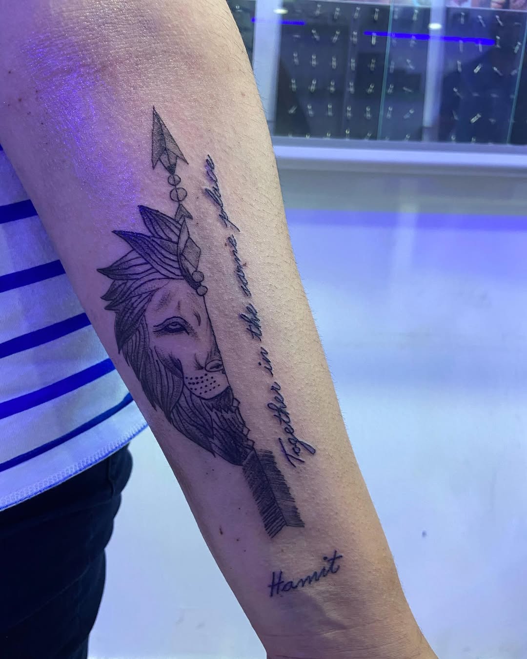 Stunning lion tattoo with unique arrow design