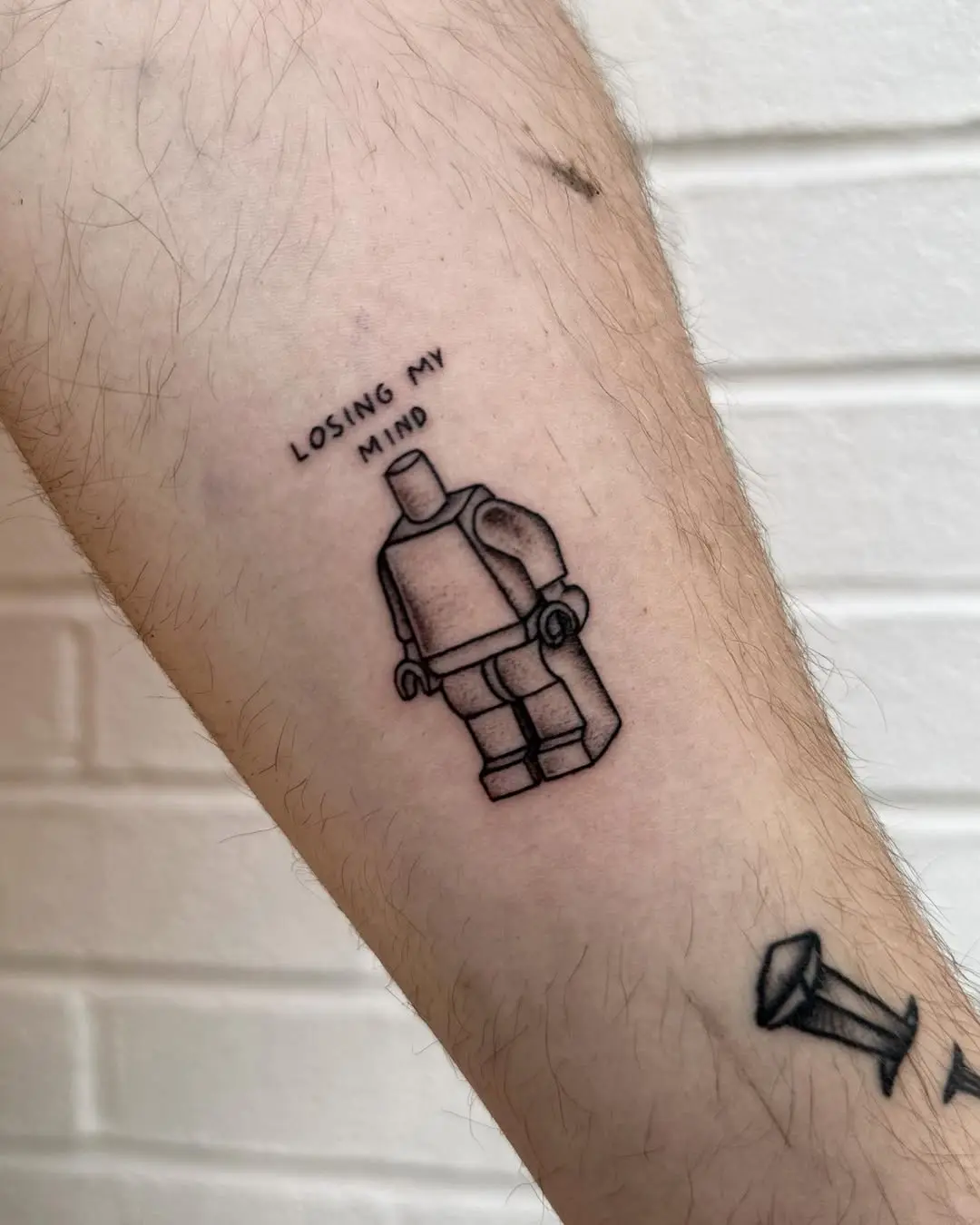Whimsical Lego-style tattoo with a twist