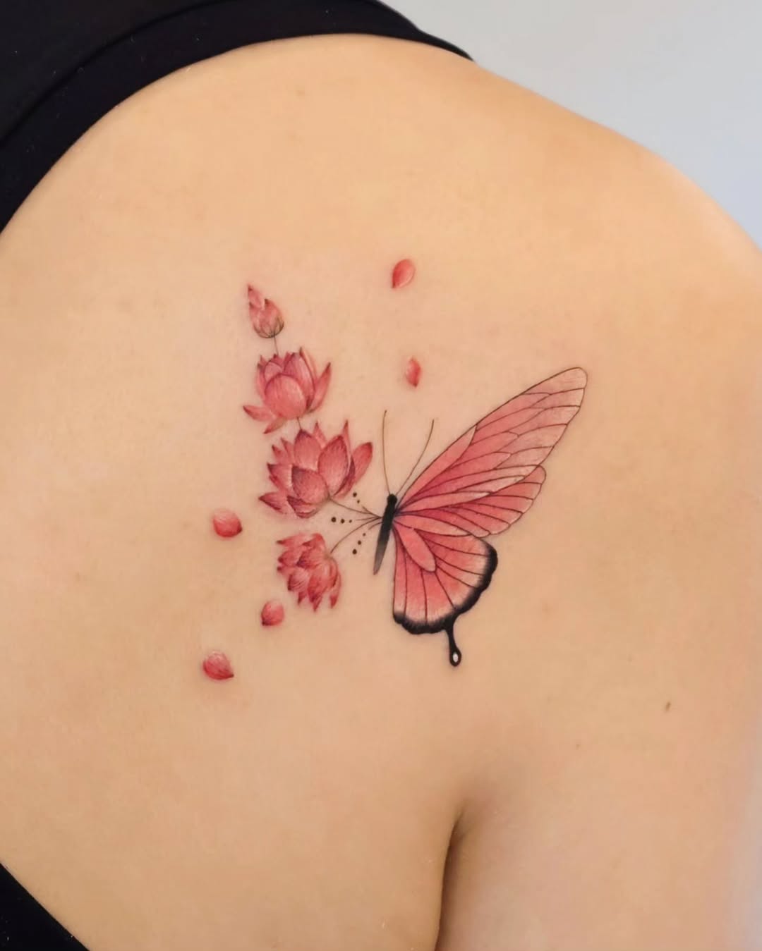 Delicate lotus and butterfly fusion tattoo design